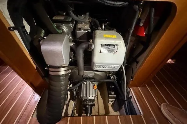 Slide: The Image of Engine compartment of a 2005 Hunter 38 sailboat, featuring a Yanmar diesel engine. - 21