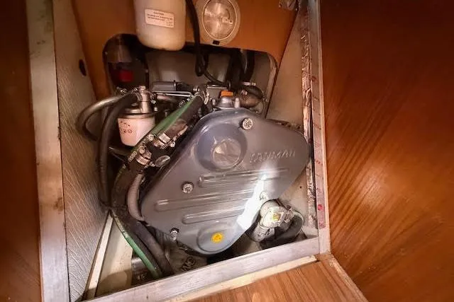 Slide: The Image of Engine compartment of a 2005 Hunter 38 sailboat, featuring a Yanmar engine. - 22
