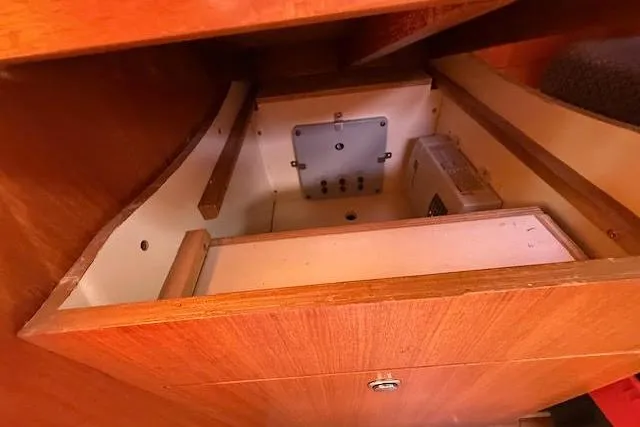 Slide: The Image of Wooden interior compartment of a 2005 Hunter 38 sailboat, showcasing storage space. - 24