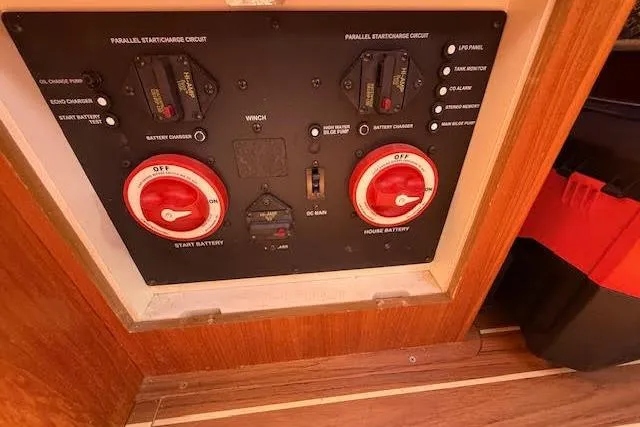 Slide: The Image of Electrical control panel on a 2005 Hunter 38 boat, featuring battery switches and circuit controls. - 25