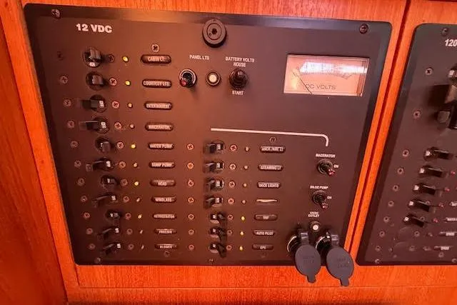 Slide: The Image of Electrical control panel on a 2005 Hunter 38 boat, featuring 12 VDC switches and indicators. - 28