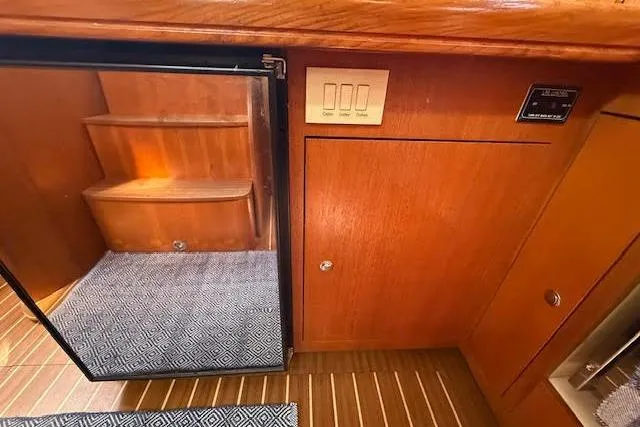 Slide: The Image of Interior of 2005 Hunter 38 yacht with wooden cabinetry and carpeted steps. - 34