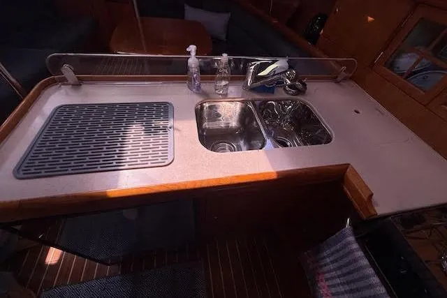 Slide: The Image of 2005 Hunter 38 yacht kitchen with dual sinks and countertop accessories. - 38