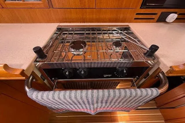 Slide: The Image of 2005 Hunter 38 yacht kitchen with a two-burner stove and towel rack. - 39