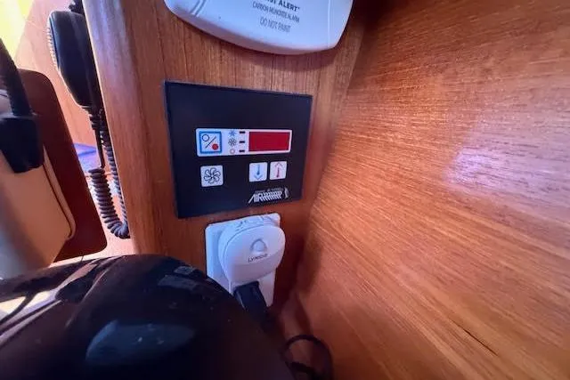 Slide: The Image of Control panel inside a 2005 Hunter 38 yacht, featuring various switches and displays. - 46