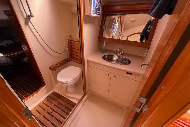 Slide: The Image of 2005 Hunter 38 yacht bathroom with shower, toilet, and sink. - 52