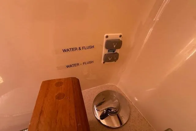 Slide: The Image of Control panel in a 2005 Hunter 38 yacht bathroom with water and flush buttons. - 55