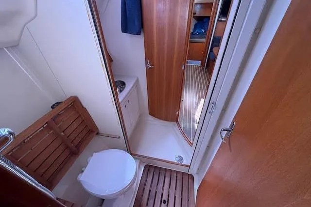 Slide: The Image of 2005 Hunter 38 yacht bathroom with wooden accents and compact design. - 56