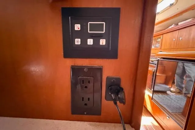Slide: The Image of Control panel and power outlet in 2005 Hunter 38 yacht interior. - 60