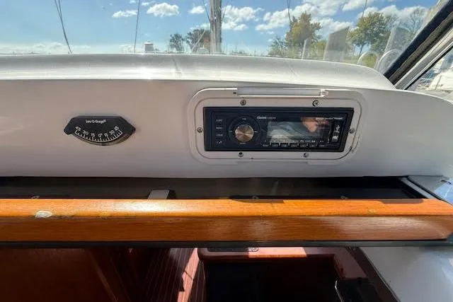 Slide: The Image of Control panel of a 2005 Hunter 38 sailboat with stereo and compass. - 61