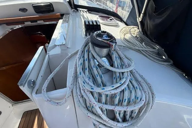 Slide: The Image of 2005 Hunter 38 sailboat deck with winch and coiled ropes. - 63