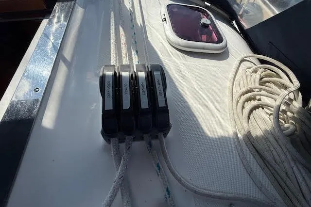 Slide: The Image of Deck of 2005 Hunter 38 sailboat with rope clutches and coiled lines. - 64