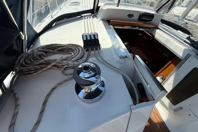 Slide: The Image of 2005 Hunter 38 sailboat cockpit with winch, ropes, and cabin entrance. - 66