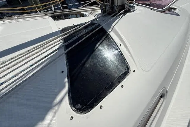 Slide: The Image of 2005 Hunter 38 sailboat deck with ropes and hatch in sunlight. - 69