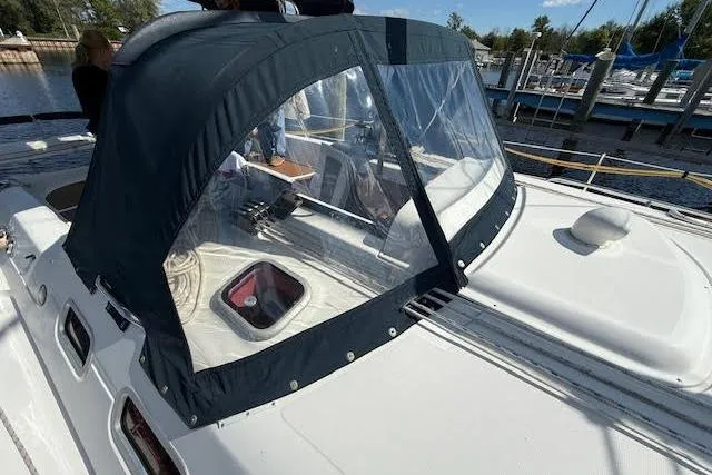 Slide: The Image of 2005 Hunter 38 sailboat with cockpit enclosure, docked at marina. - 71