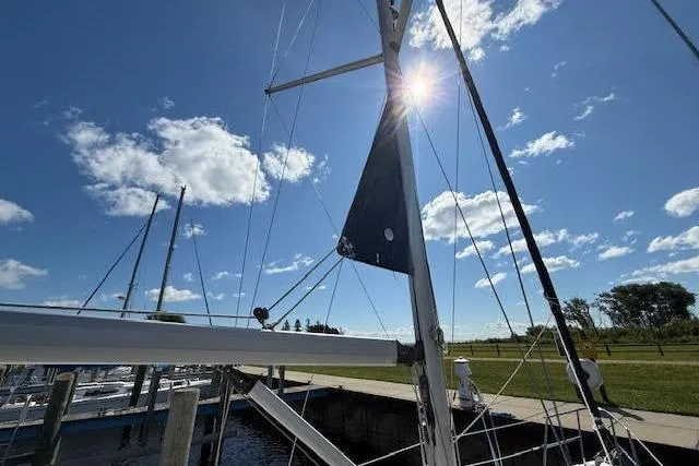 Slide: The Image of Sailboat mast of 2005 Hunter 38 under sunny blue sky at marina. - 72