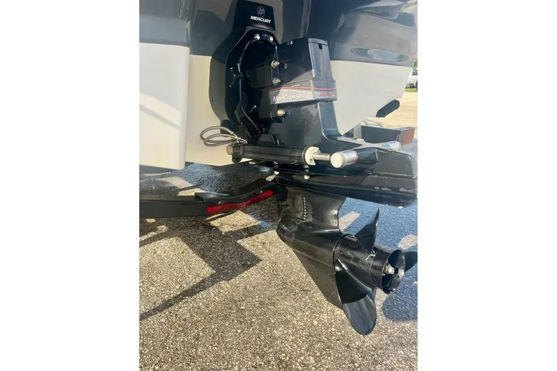 Slide: The Image of 2017 Chaparral 21 H2O Sport boat with Mercury outboard motor, parked on pavement. - 10