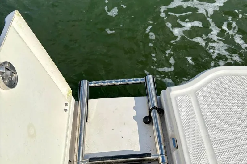 Slide: The Image of 2017 Chaparral 21 H2O Sport boat ladder and platform by water. - 12