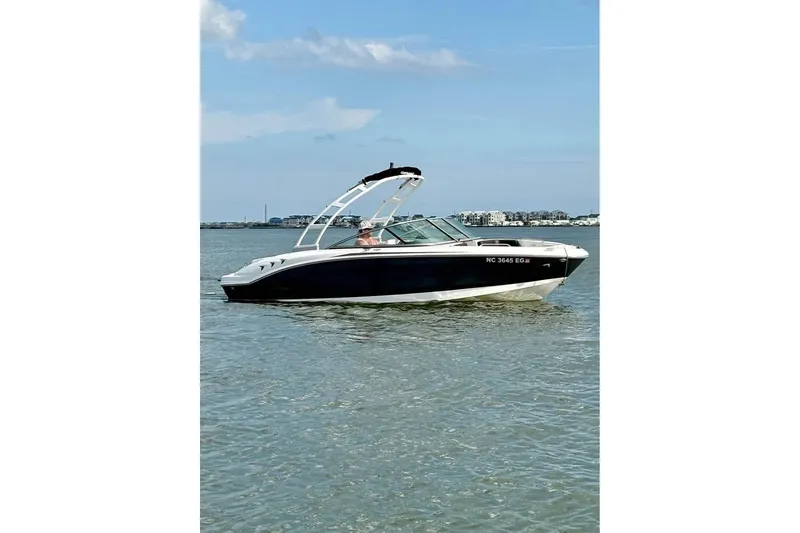 Slide: The Image of 2017 Chaparral 21 H2O Sport boat on calm water under blue sky. - 2