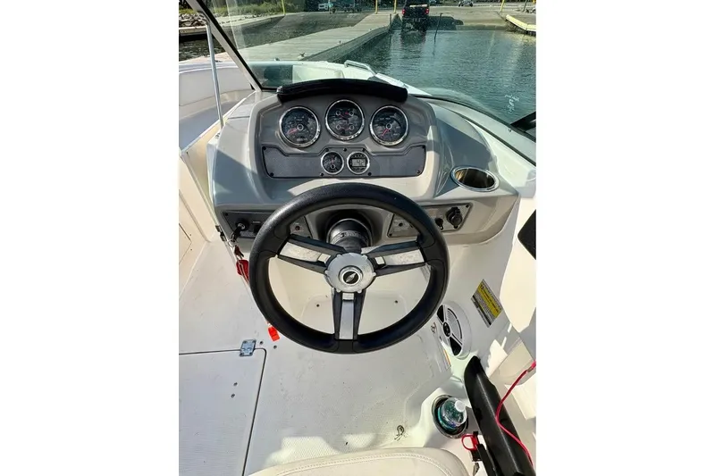 Slide: The Image of 2017 Chaparral 21 H2O Sport boat dashboard with steering wheel and gauges. - 8