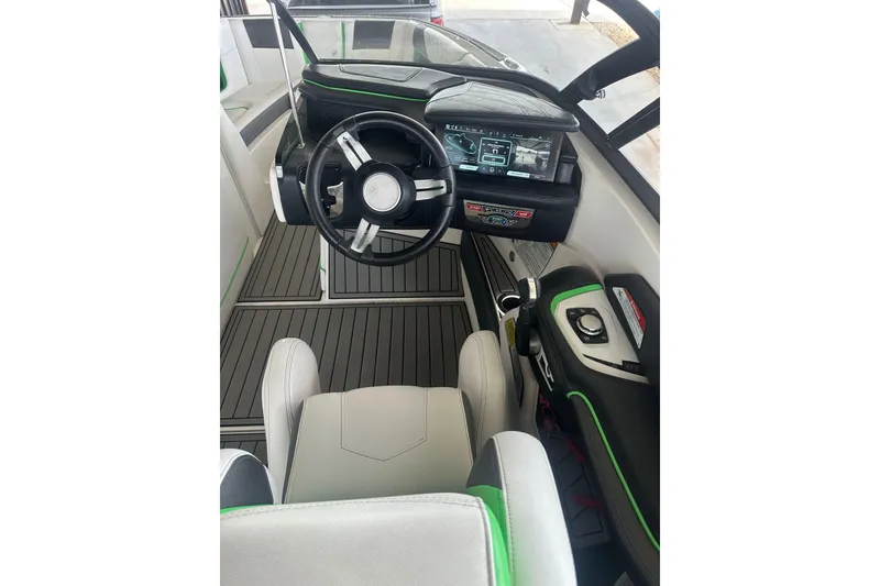 Slide: The Image of 2017 Nautique Super Air Nautique G21 cockpit with modern steering and dashboard controls. - 10