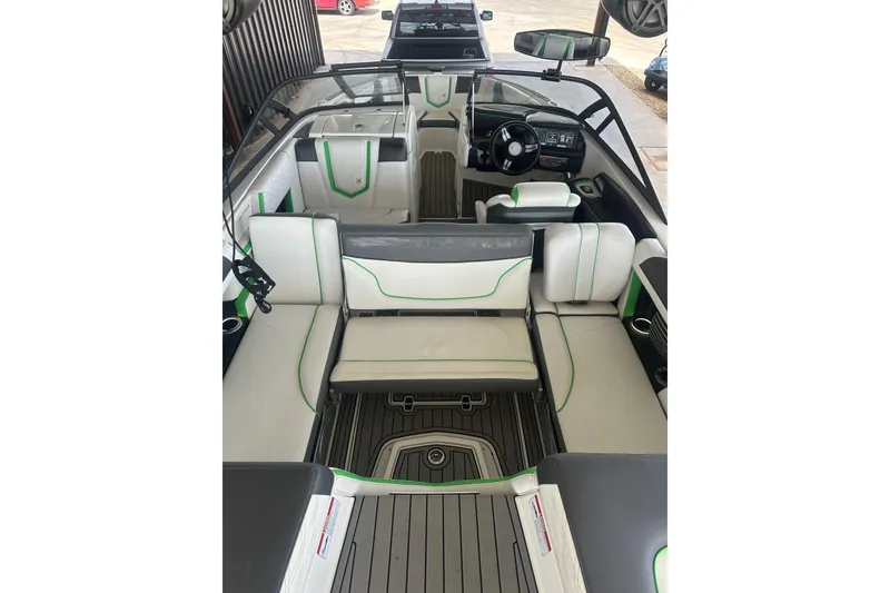 Slide: The Image of 2017 Nautique Super Air Nautique G21 interior with white and green seating, modern dashboard. - 15