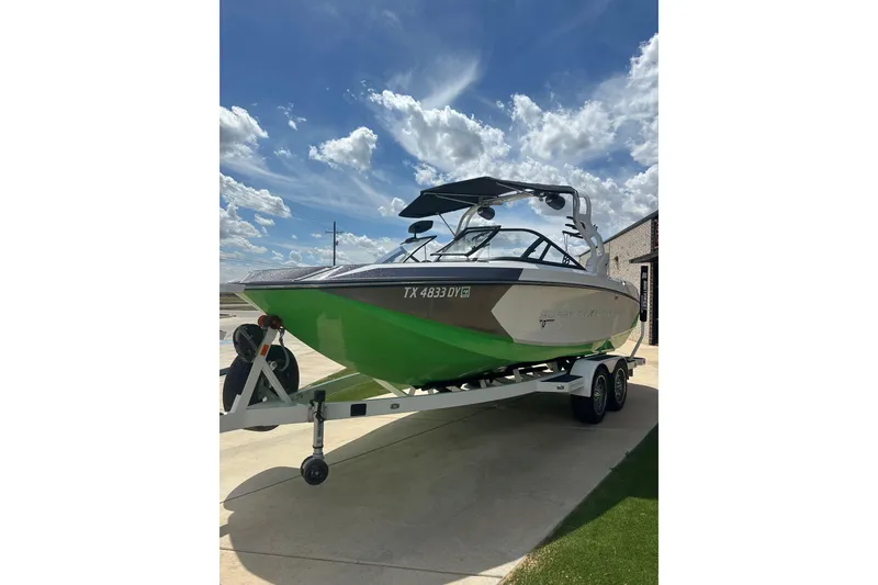 Slide: The Image of 2017 Nautique Super Air Nautique G21 boat on trailer under blue sky. - 4