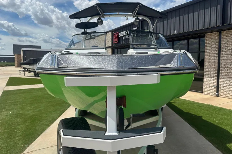 Slide: The Image of 2017 Nautique Super Air Nautique G21 boat in vibrant green, parked outdoors. - 5