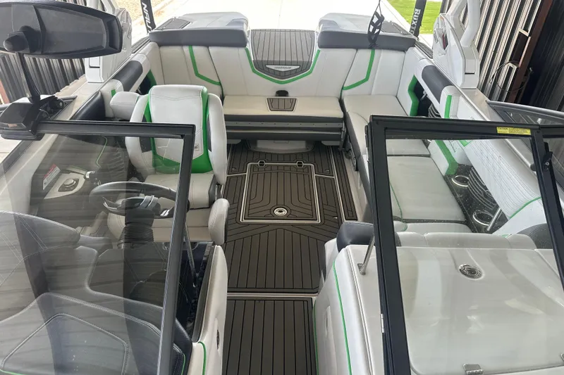 Slide: The Image of 2017 Nautique Super Air Nautique G21 interior with white and green seating, black flooring. - 7