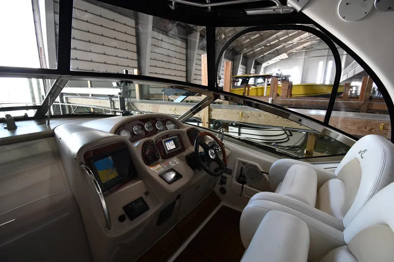 Slide: The Image of Interior cockpit of 2008 Sea Ray 340 Sundancer yacht, featuring navigation controls and plush seating. - 12