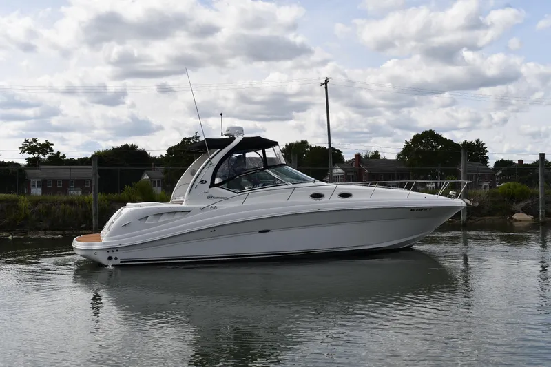 Slide: The Image of 2008 Sea Ray 340 Sundancer yacht on calm water under cloudy sky. - 2