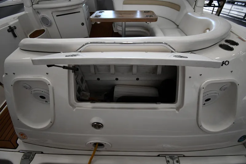 Slide: The Image of 2008 Sea Ray 340 Sundancer interior with open storage compartment and seating area. - 29