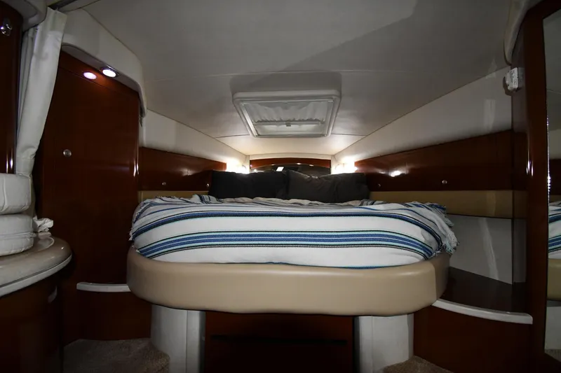 Slide: The Image of Luxurious cabin interior of 2008 Sea Ray 340 Sundancer with cozy bed and ambient lighting. - 31