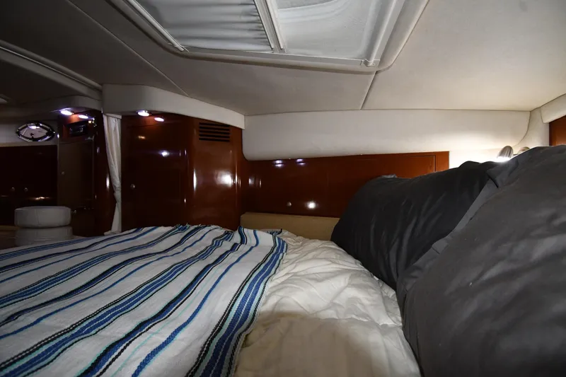 Slide: The Image of Interior cabin of 2008 Sea Ray 340 Sundancer with cozy bedding and ambient lighting. - 34
