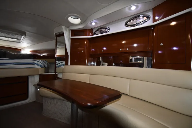 Slide: The Image of 2008 Sea Ray 340 Sundancer interior with elegant wood finish and cozy seating area. - 36