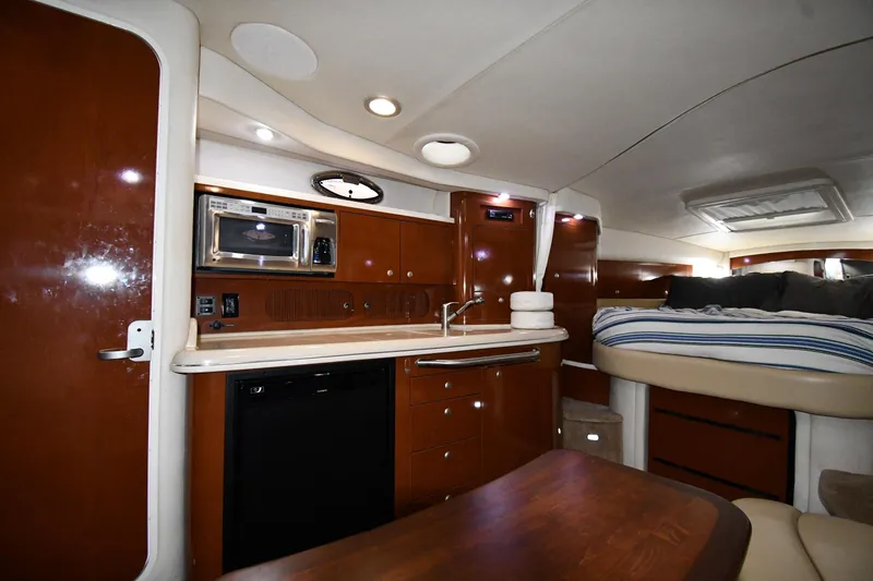 Slide: The Image of Interior of 2008 Sea Ray 340 Sundancer yacht with kitchenette and cozy sleeping area. - 37
