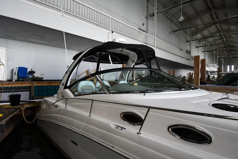 Slide: The Image of 2008 Sea Ray 340 Sundancer yacht docked indoors, showcasing sleek design and luxury features. - 4