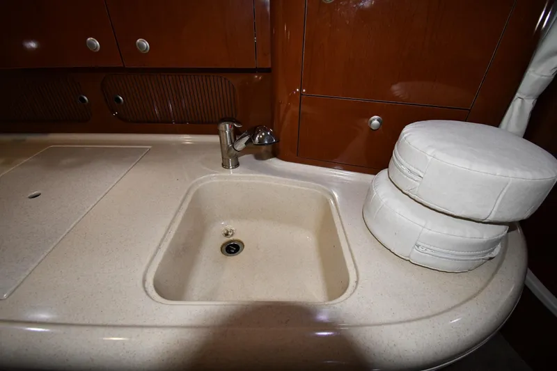 Slide: The Image of 2008 Sea Ray 340 Sundancer interior sink with countertop and storage cabinets. - 40