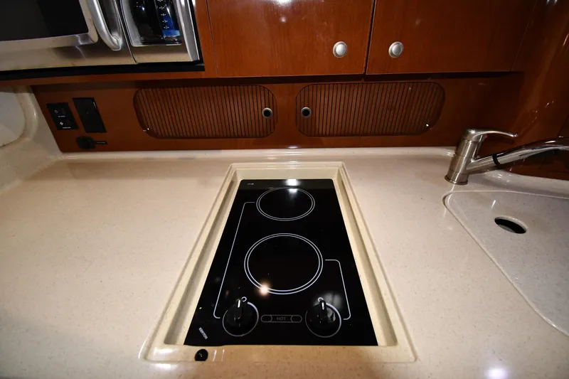 Slide: The Image of 2008 Sea Ray 340 Sundancer kitchen with stovetop and sink. - 41