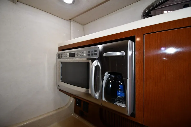 Slide: The Image of 2008 Sea Ray 340 Sundancer kitchen with microwave and coffee maker. - 42