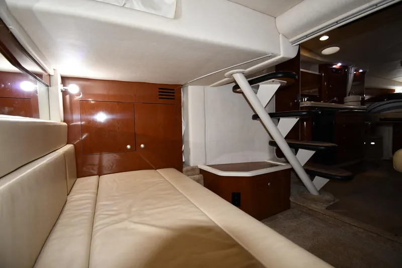 Slide: The Image of 2008 Sea Ray 340 Sundancer interior with beige seating and wooden cabinetry. - 47