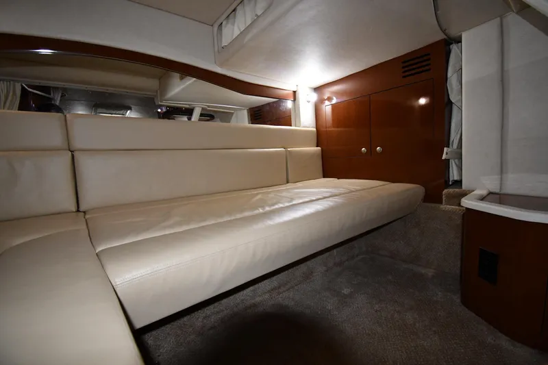 Slide: The Image of Luxurious interior of 2008 Sea Ray 340 Sundancer with beige leather seating and wooden accents. - 48