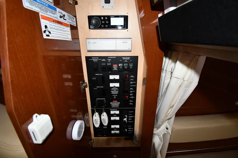Slide: The Image of Control panel inside 2008 Sea Ray 340 Sundancer boat, featuring switches and gauges. - 49