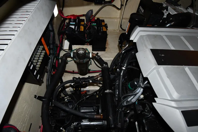 Slide: The Image of Engine compartment of a 2008 Sea Ray 340 Sundancer with visible batteries and wiring. - 56