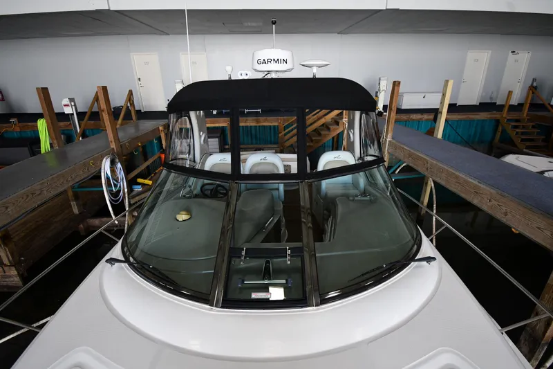 Slide: The Image of 2008 Sea Ray 340 Sundancer docked indoors, featuring Garmin navigation equipment. - 8