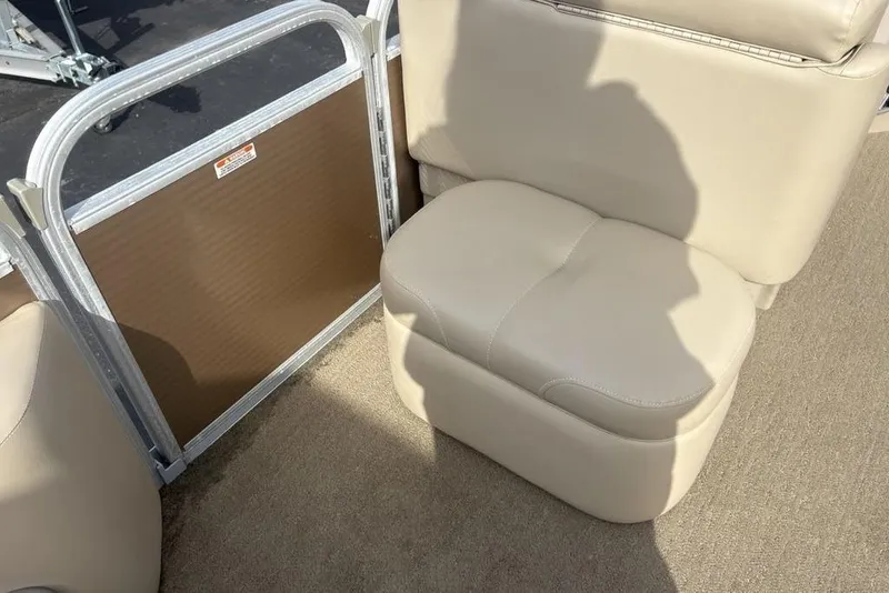 Slide: The Image of 2015 Bennington 24 SSRX boat interior with beige seating and metal railing. - 12