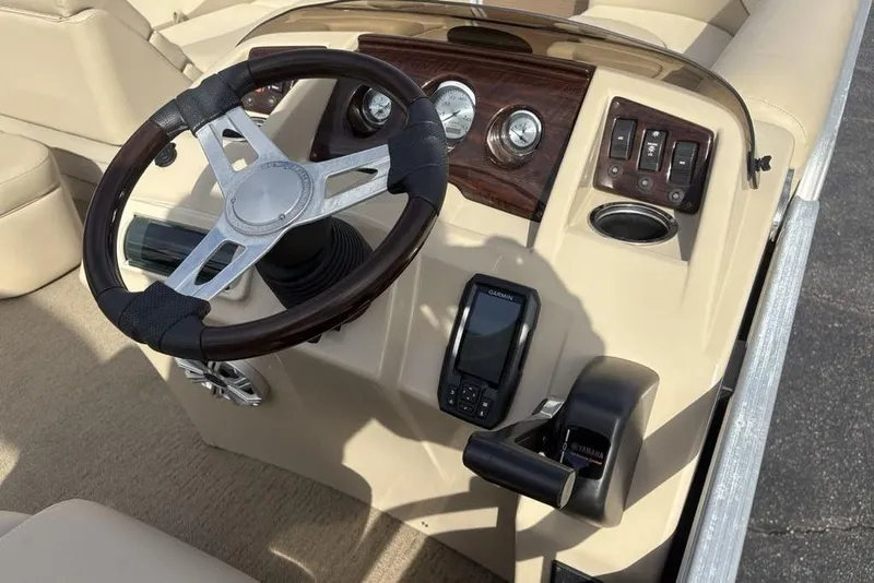 Slide: The Image of Steering console of 2015 Bennington 24 SSRX boat with Garmin device and controls. - 14