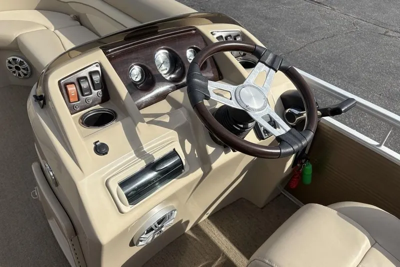 Slide: The Image of Steering console of a 2015 Bennington 24 SSRX pontoon boat with gauges and controls. - 15