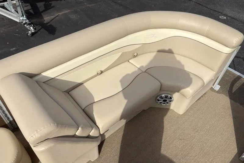 Slide: The Image of Beige seating area on a 2015 Bennington 24 SSRX pontoon boat. - 2