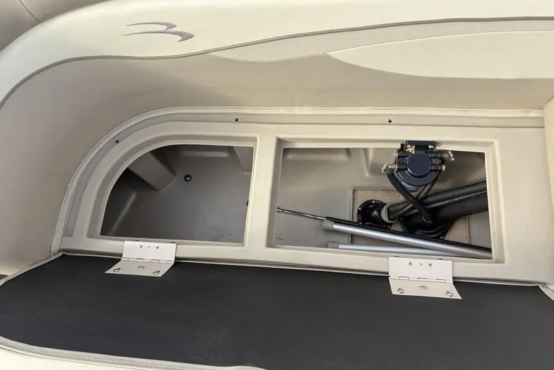 Slide: The Image of Open storage compartment in a 2015 Bennington 24 SSRX boat, showing interior details. - 20